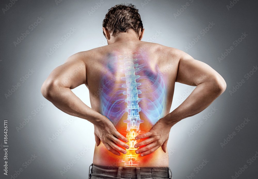 Lower back pain. Man holding his back in pain. Medical concept.